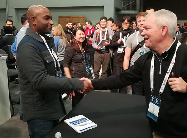 Pivotalのブースで著書を配布し、握手を行うHightower氏