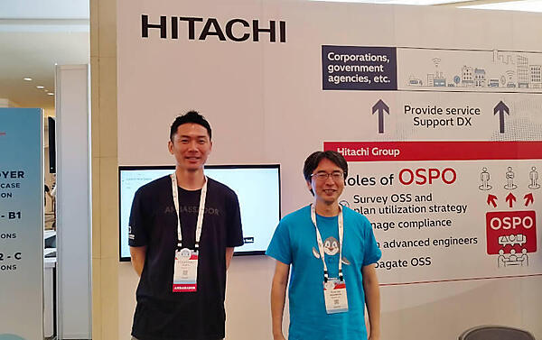 KubeCon Japanの日立ブースで記念撮影。右が中村雄一氏、左は田畑義之氏<sup>※</sup>