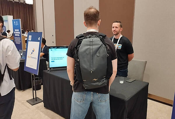 OpenTelemetryのブースで質問に答えるSteve Flanders氏